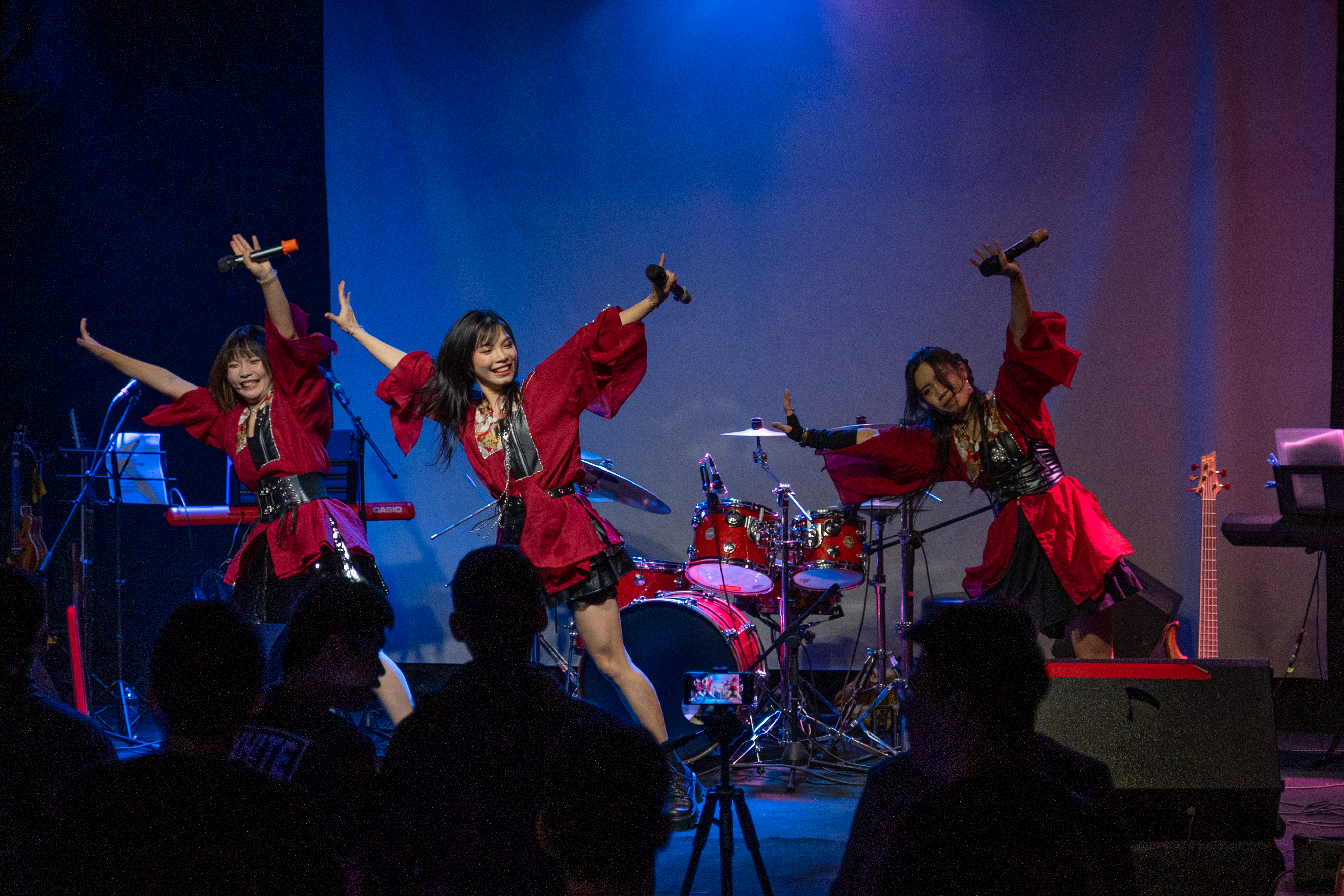 POLARIS on stage, arms raised under blue light